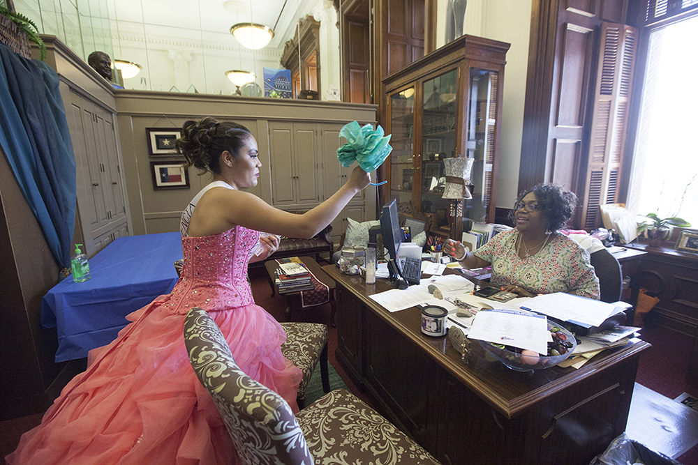 Alexandra Lopez delivers a flower to the staff of Representative Senfronia Thompson, who has worked to defeat SB4.